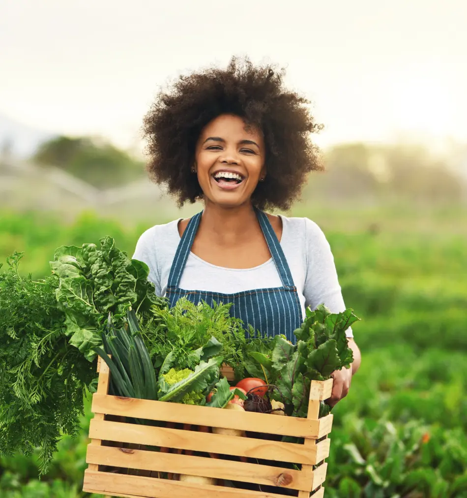 A woman with a box of vegetables